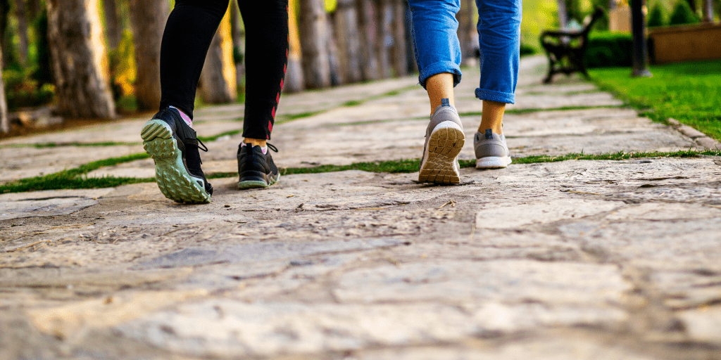 Two women walking away on a path through a park in Branson West, MO