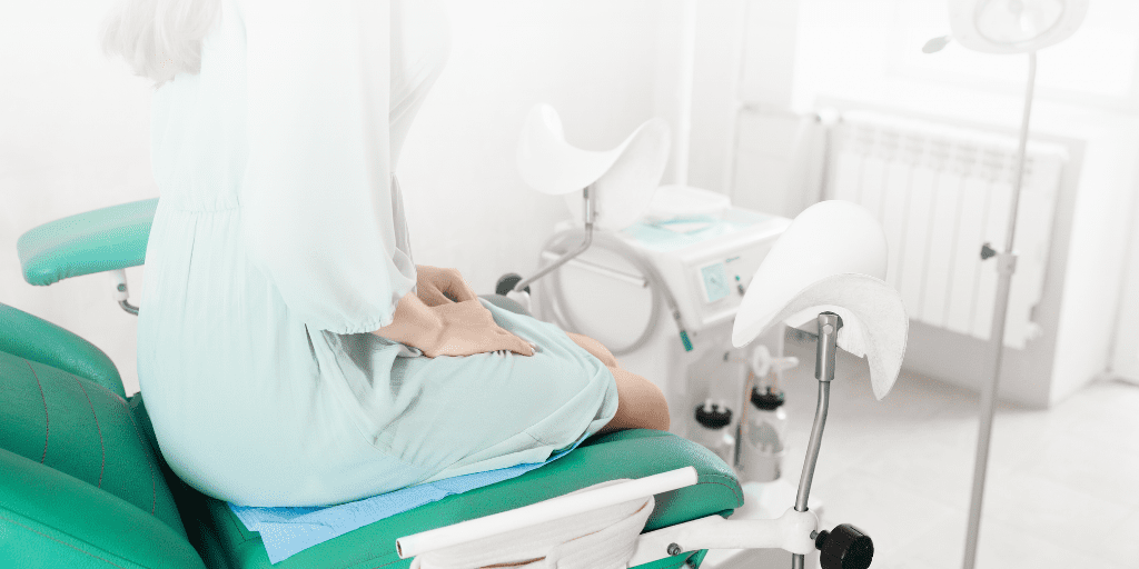 Woman sets in medical exam room