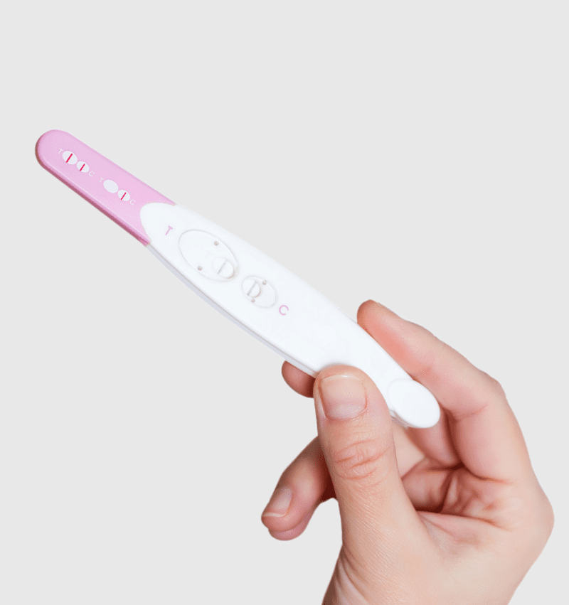 A woman holding a free pregnancy test at PLL Womens Resource Center