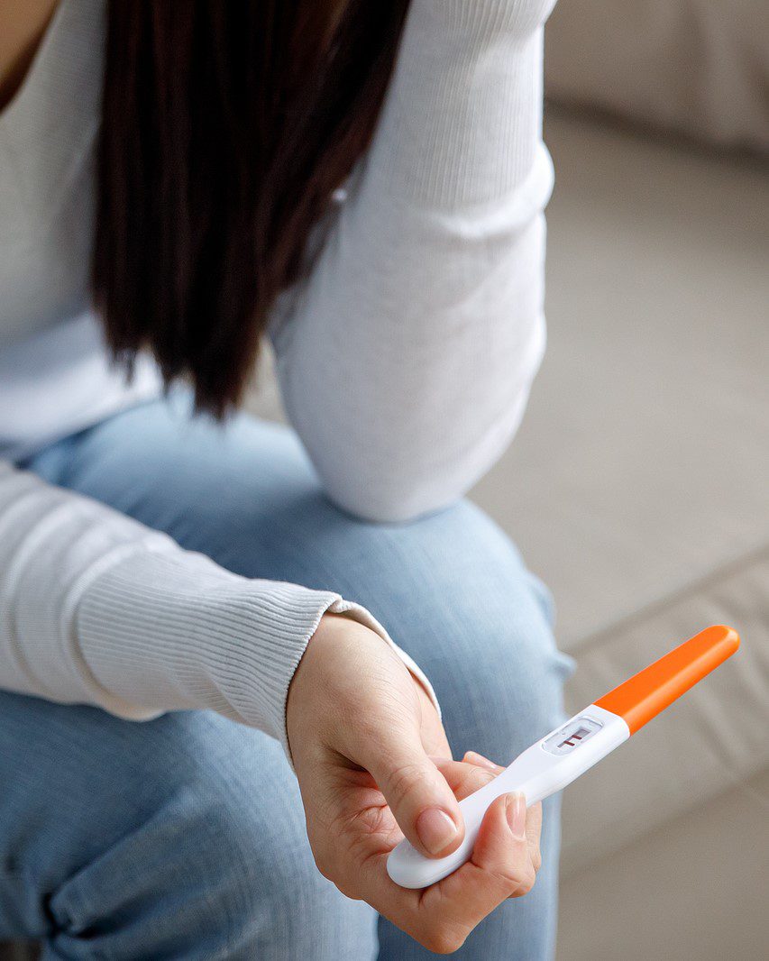 Woman holding a free pregnancy test