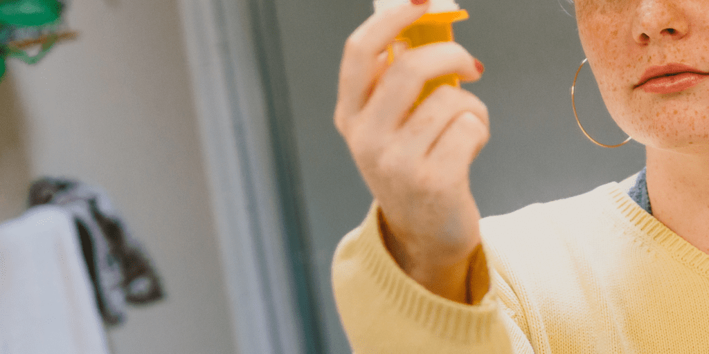 woman holds prescription pill bottle